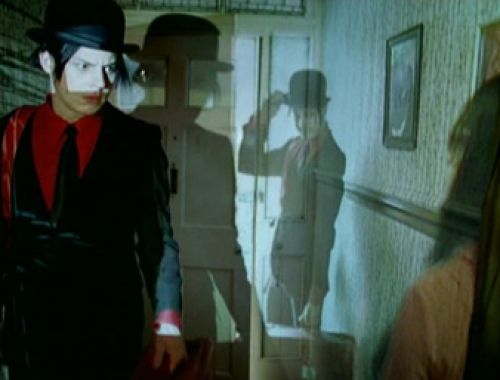 Jack and Meg White performing with their images projected onto walls, creating overlapping visuals from the music video.
