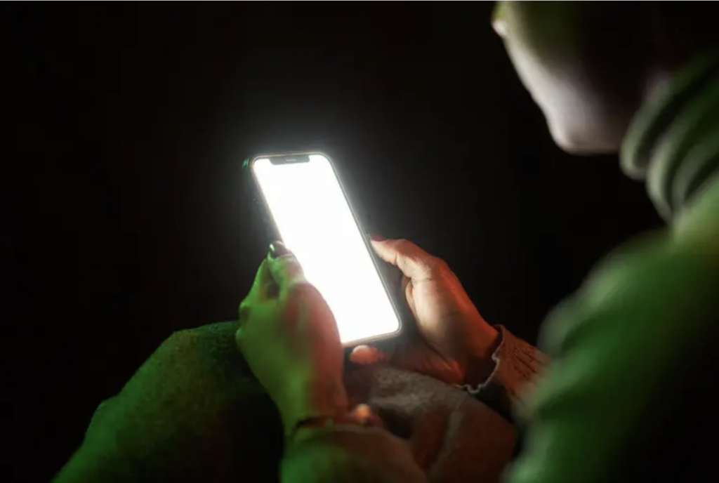 a person on their phone in the dark