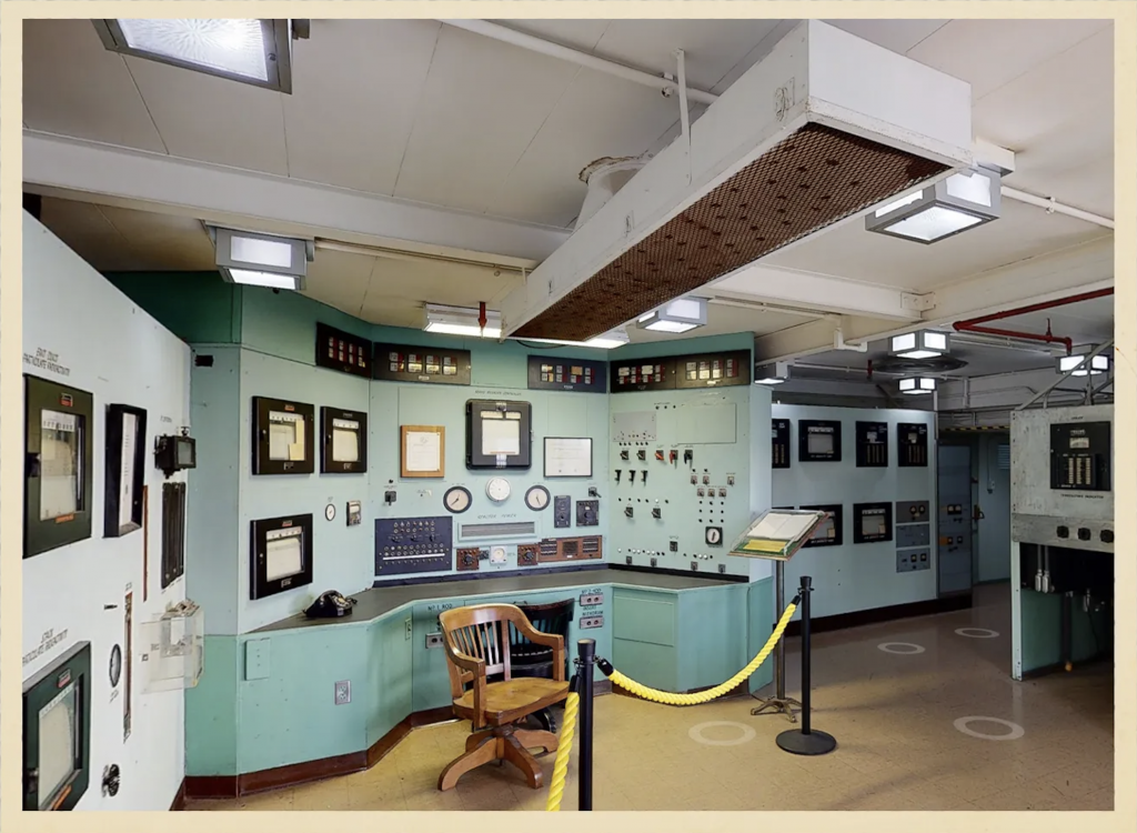 a seafoam green walled industrial control room wth chair circa 1950s