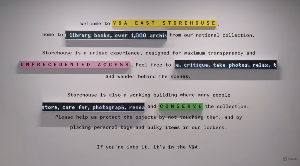 A typographic wall installation at V&A East Storehouse displaying a visitor welcome message in monospaced text, with key phrases such as "UNPRECEDENTED ACCESS" and "CONSERVE" highlighted in coloured LED-style ticker panels.