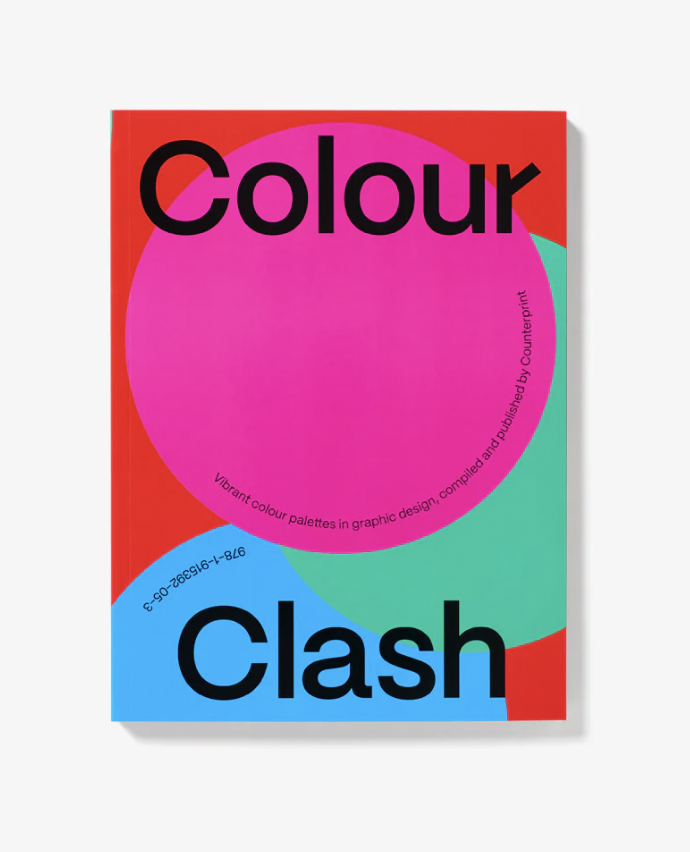 Bright, modern book cover titled ‘Colour Clash’ featuring bold overlapping shapes in vivid pink, red, teal, and blue. The large black title text sits over a central pink circular form, with smaller curved text around it describing vibrant colour palettes in graphic design.